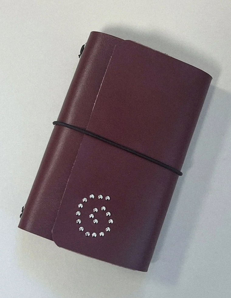 The Spiral Field Journal in oxblood leather with black elastic