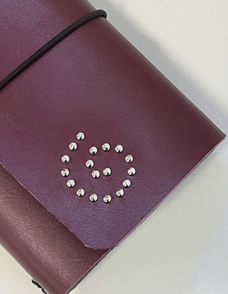 Silver eyelet spiral on the oxblood Spiral Field Journal