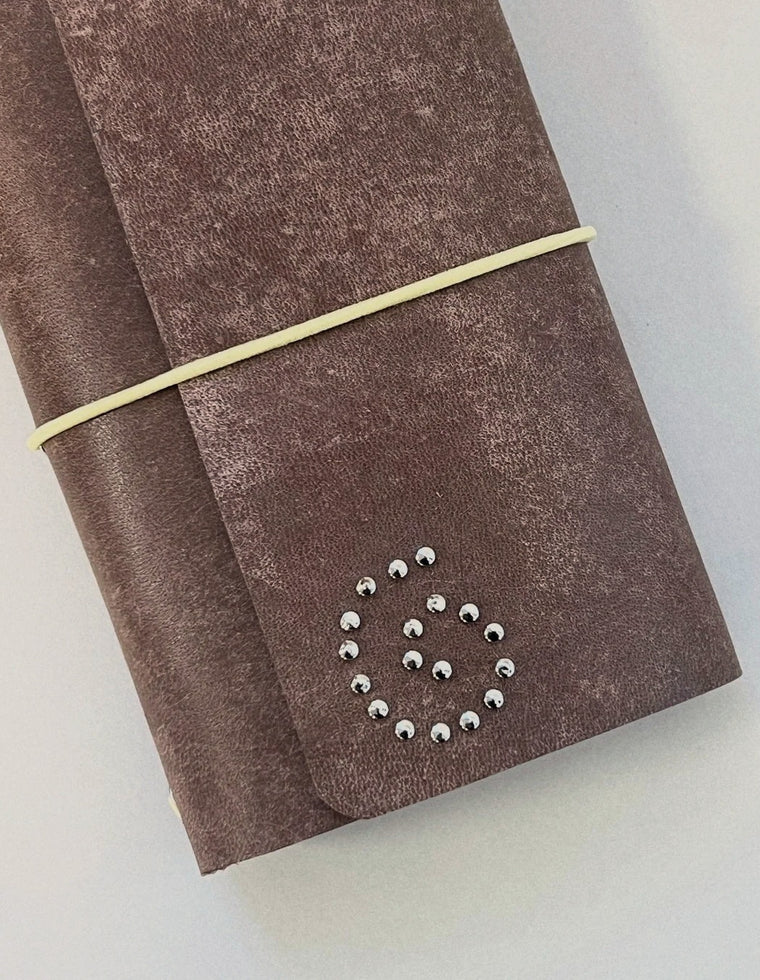 Silver eyelet spiral on the brown patina Spiral Field Journal