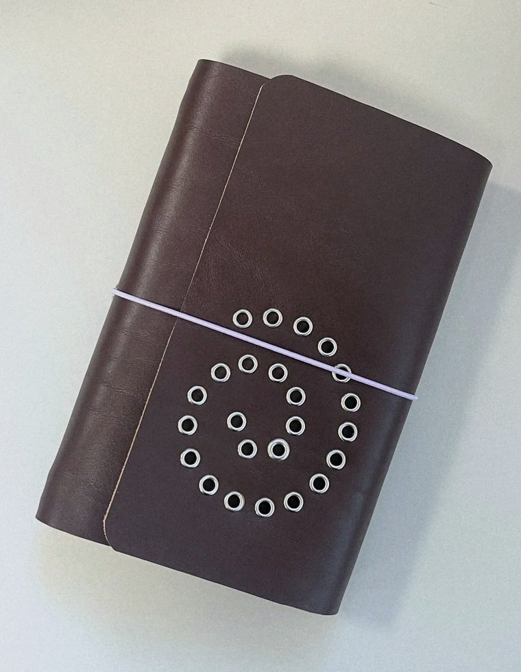 The A5 Spiral Journal in chestnut leather with lilac elastic