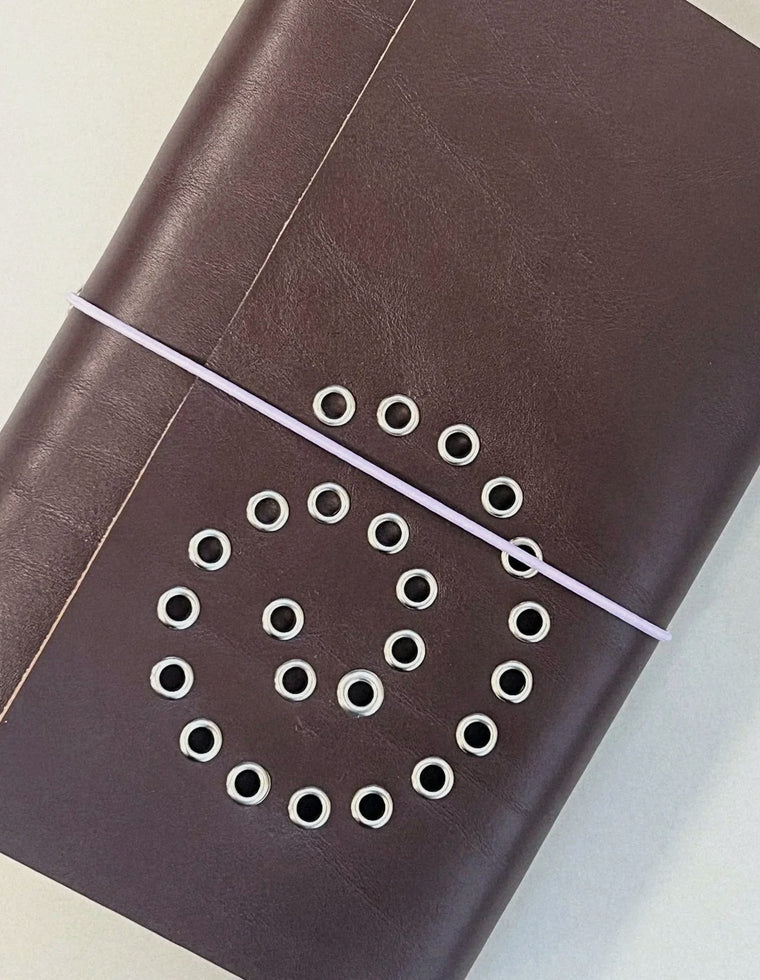 Oversized silver eyelet spiral on the chestnut A5 Spiral Journal