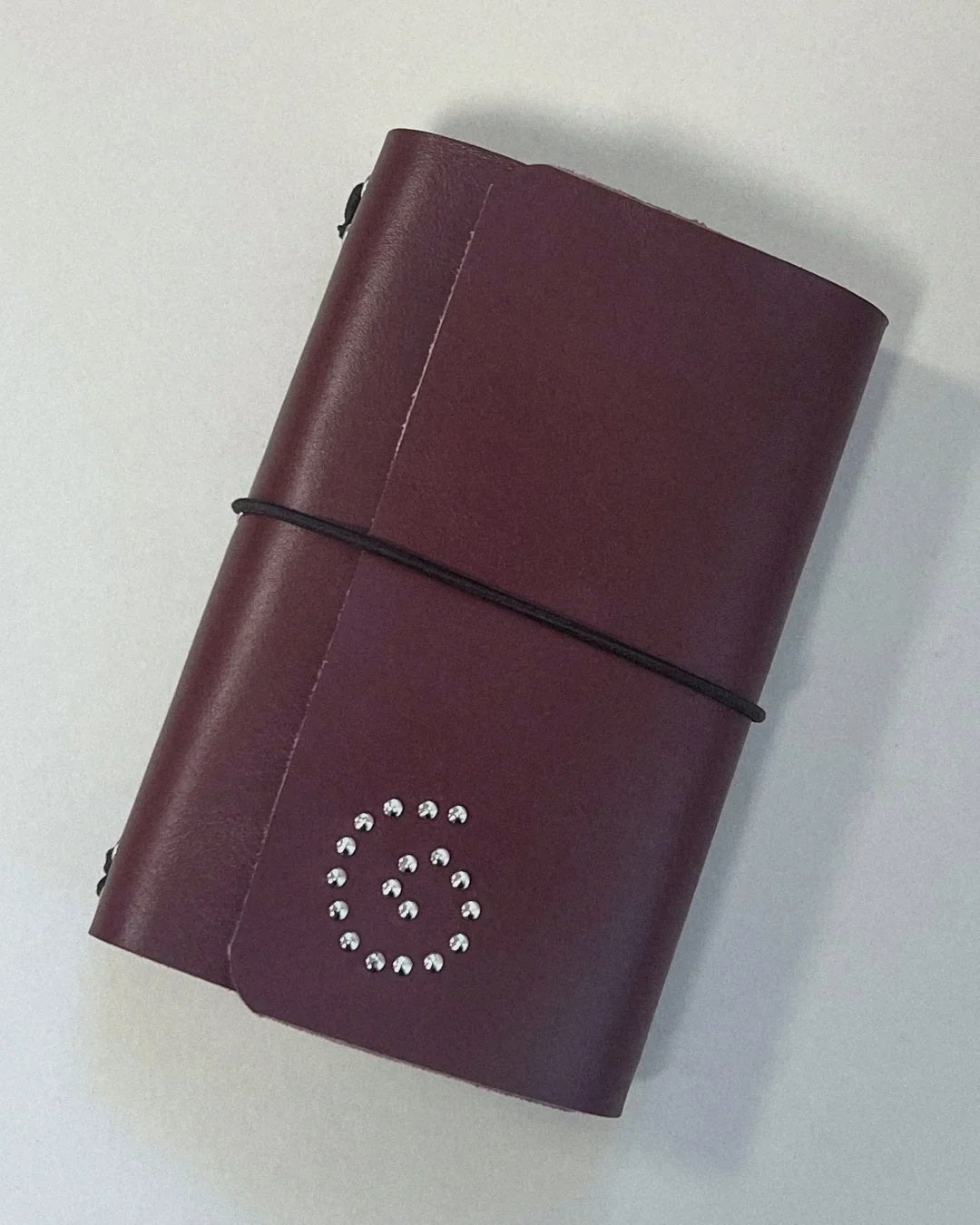 The Spiral Field Journal in oxblood leather with black elastic