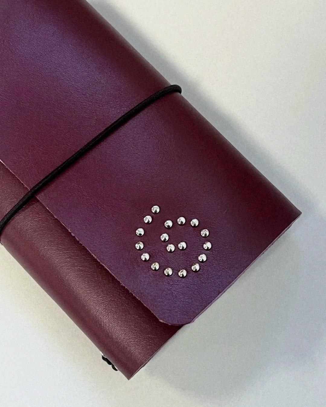 Oxblood Spiral Field Journal closed with black elastic