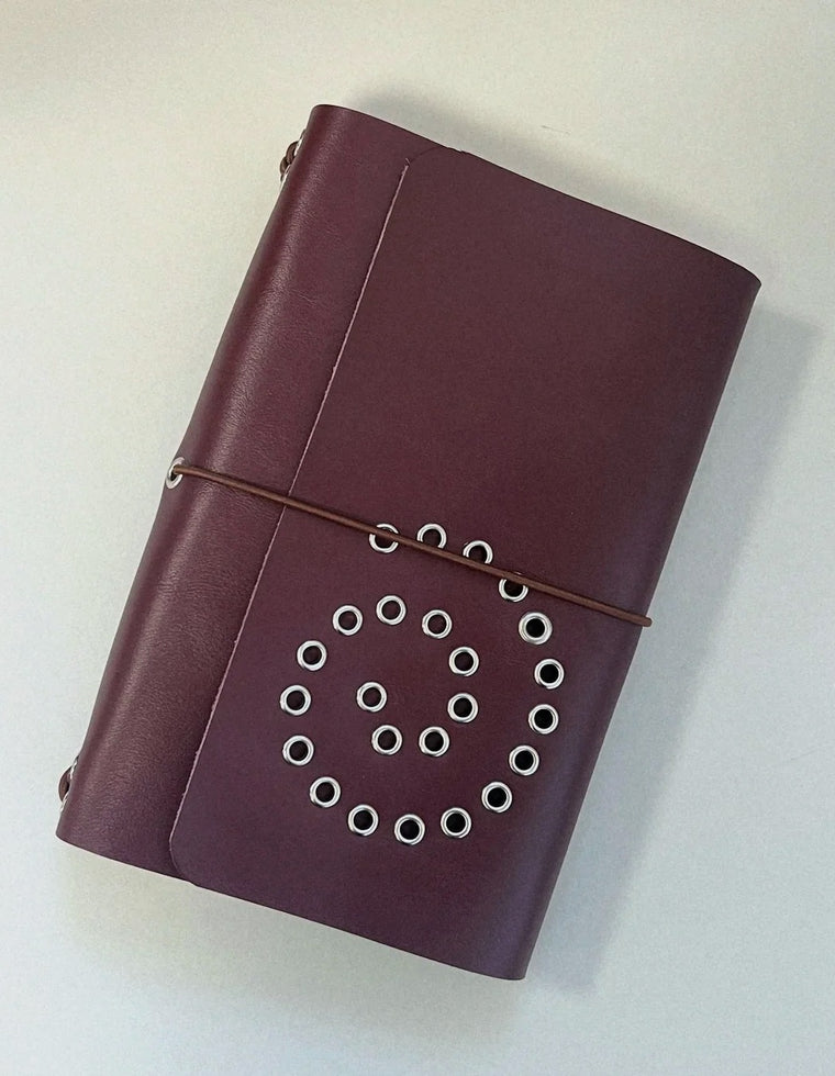 The A5 Spiral Journal in oxblood leather with brown elastic